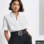 Home 18 패션 코디네이터의 개인 브랜드 구축 사례 - A stylish fashion coordinator in a modern urban studio, confidently showcasing a monochrome outfit w...